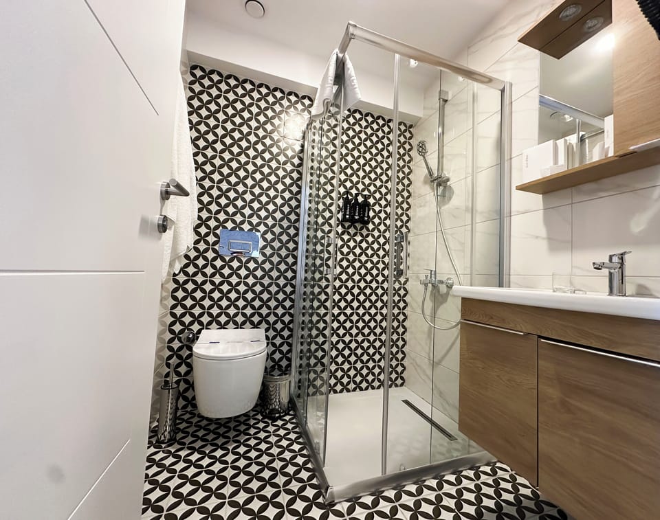 Shower, designer toiletries, hair dryer, bathrobes