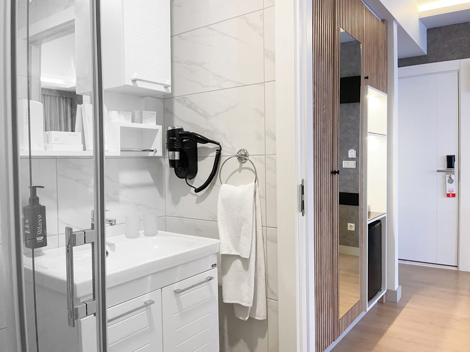 Shower, designer toiletries, hair dryer, bathrobes
