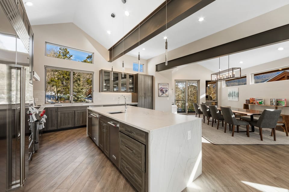 Chef's kitchen with quartz countertops and a dining area with seating for 10.