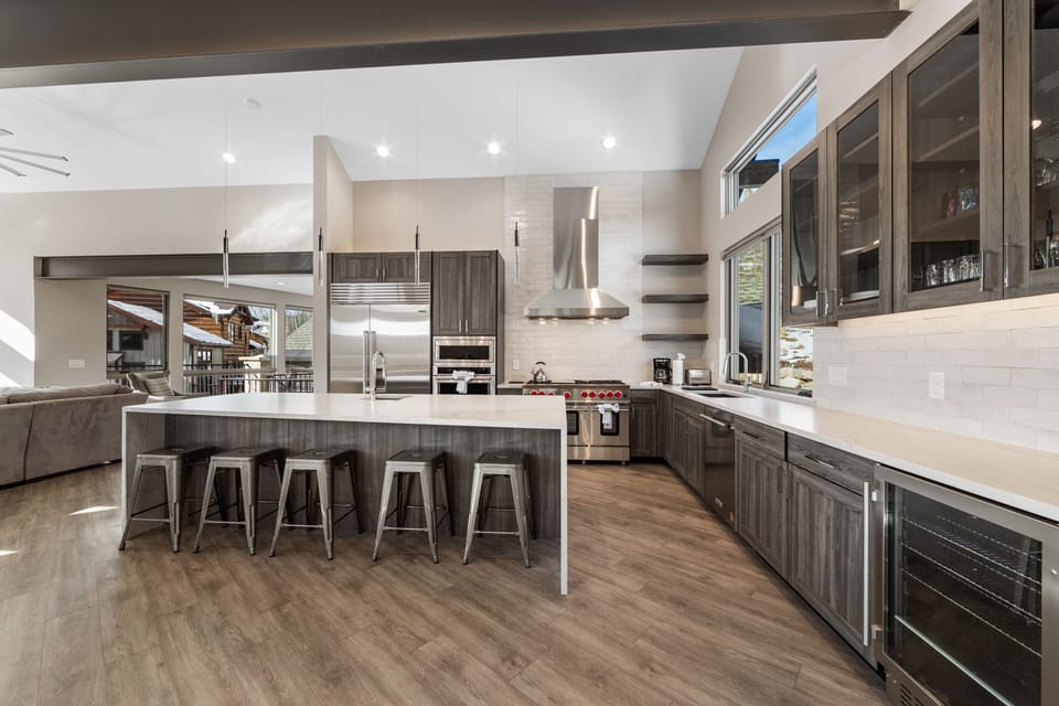 Chef's kitchen with quartz countertops and a breakfast bar with seating for 5.