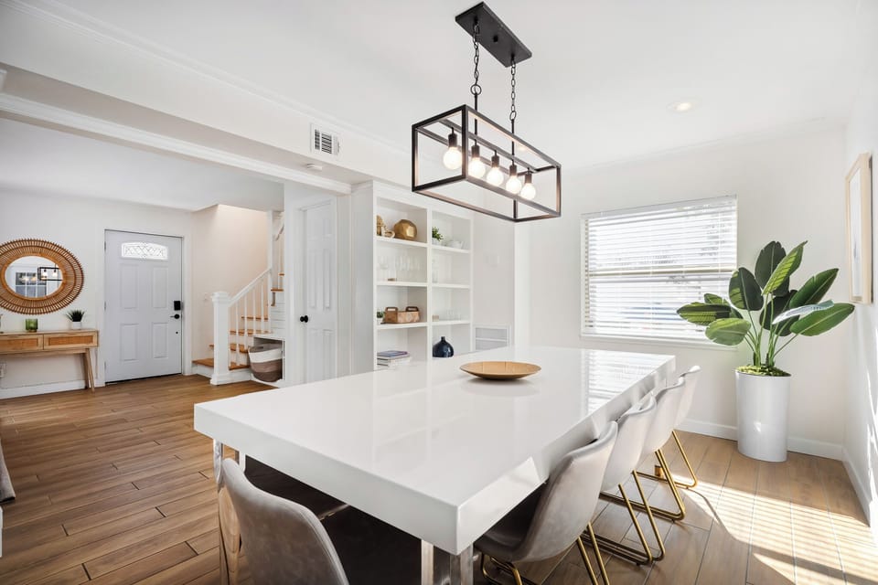 Bright modern dining room with designer lighting and abundant natural light