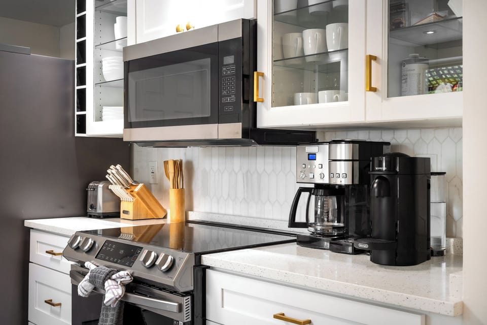 Modern, fully equipped kitchen with stainless appliances and coffee station