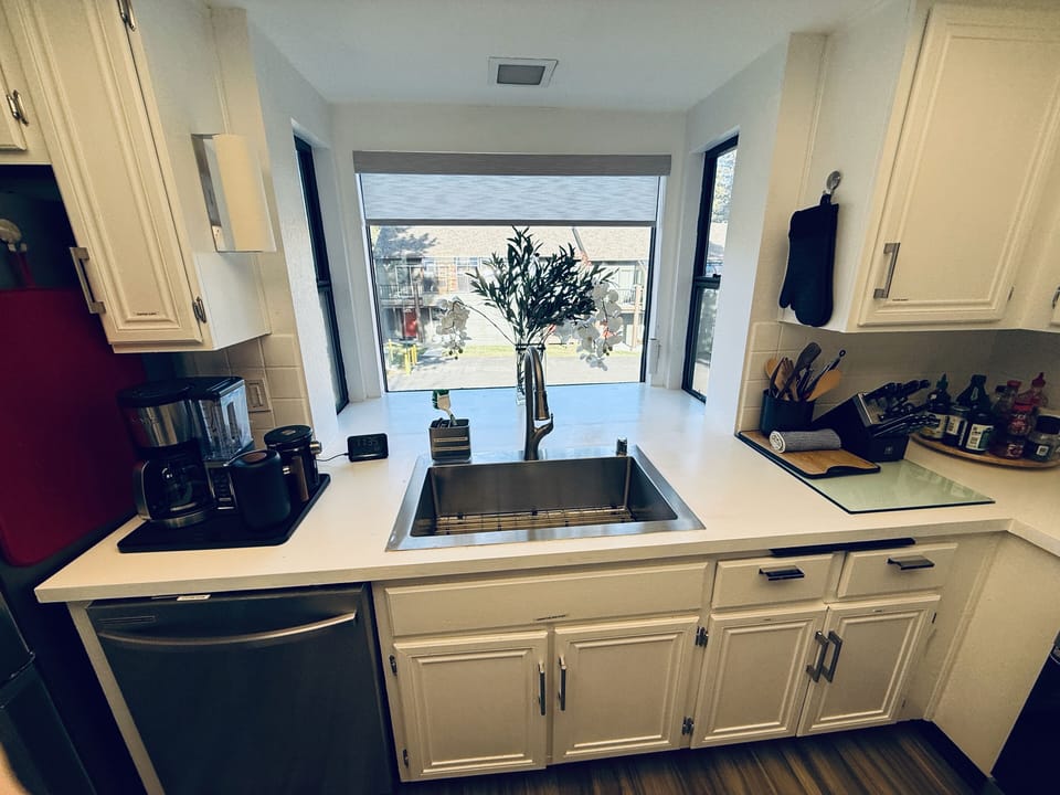Open, airy fully equipped kitchen with coffee station, wine fridge, DW.
