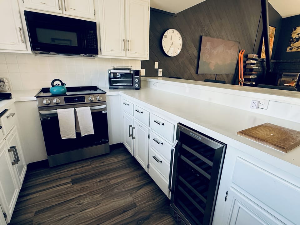 Newly renovated kitchen with new appliances including a wine fridge.