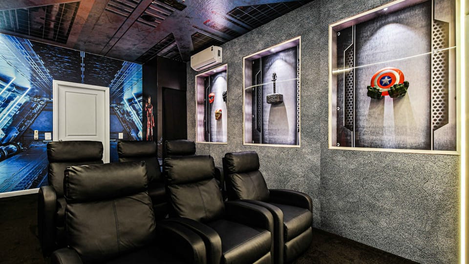 Marvel-themed home theater with luxe recliners, hero displays, and cinematic atmosphere.

