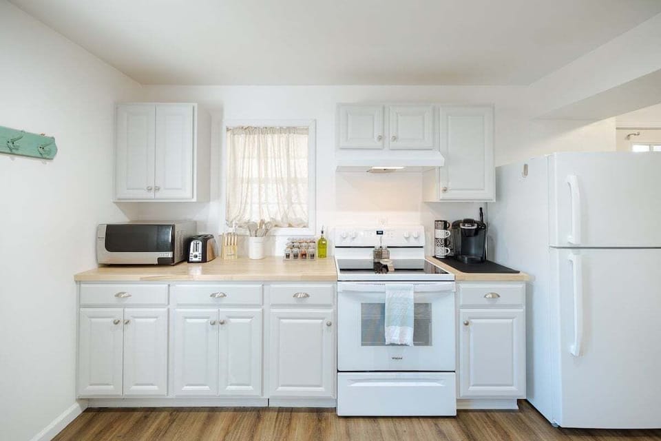 Spacious kitchen with full appliances, cookware, spices, and essentials.