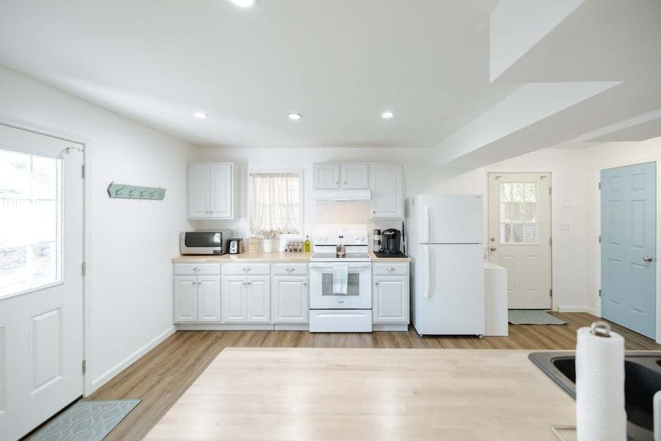 Spacious kitchen with full appliances, cookware, spices, and essentials.