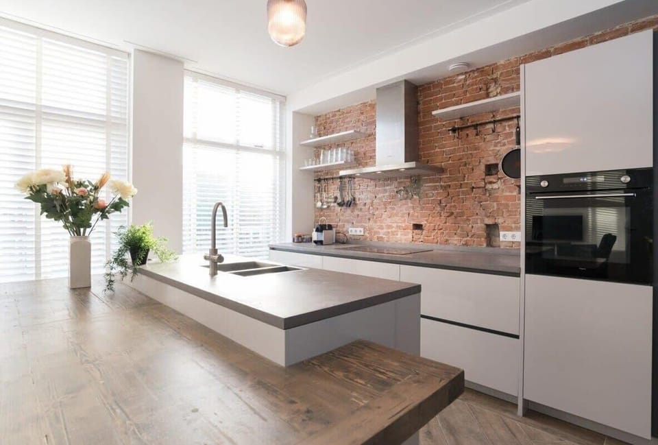 Kitchen with "boiling water tap", induction cooking plate, and plenty of cookware and equipment