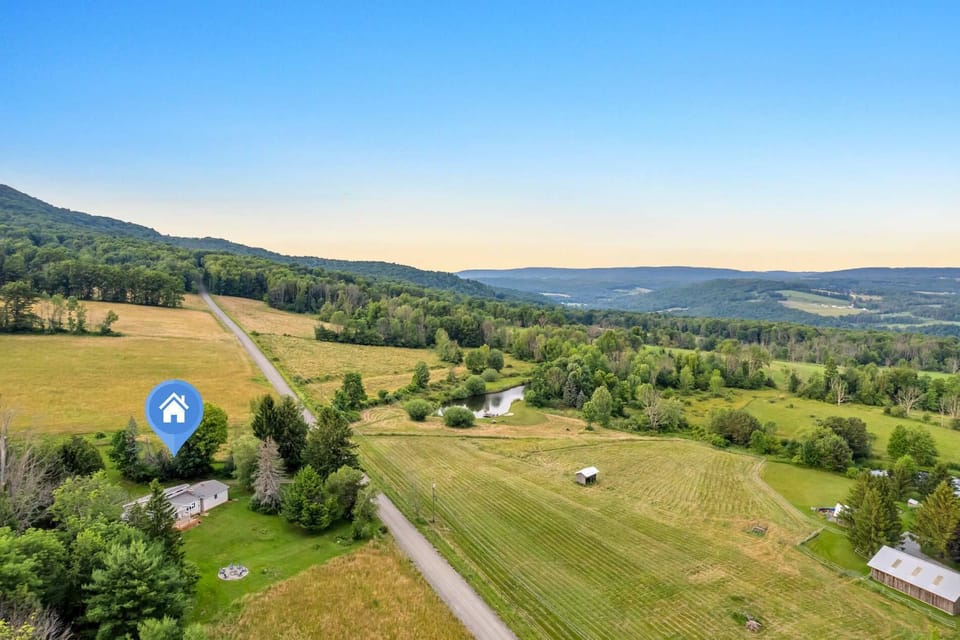 Find your lodge tucked along a quiet country road, with a pond, farmland, and mountains all part of the same private view.
