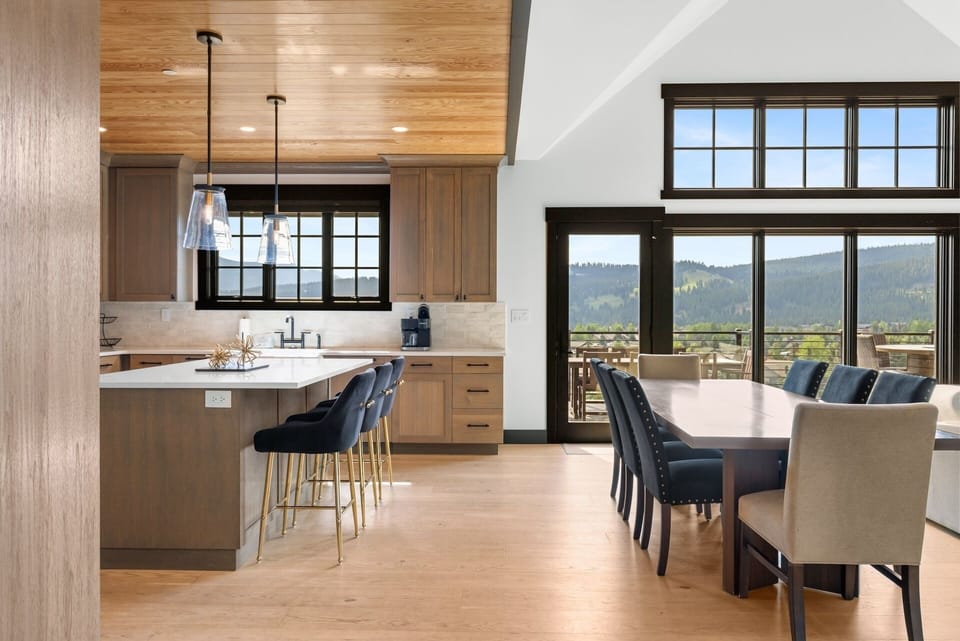 Gather around the spacious kitchen island or settle into the dining area—both perfectly positioned so you can enjoy stunning mountain views while you cook, dine, and connect.