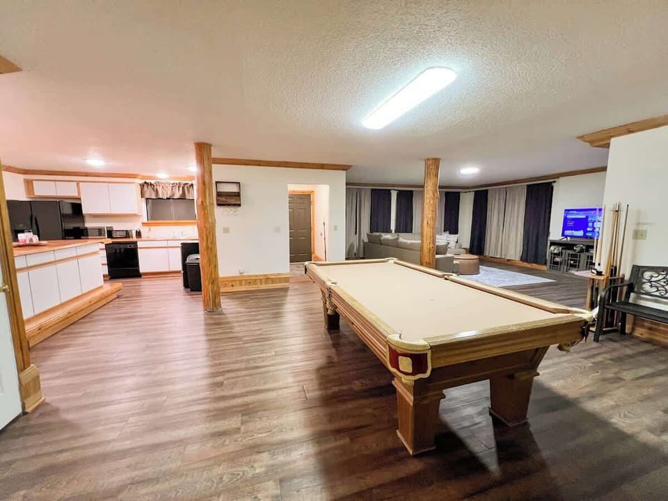 The second living area downstairs has a Pool Table, second kitchen, second living room, and an additional entrance