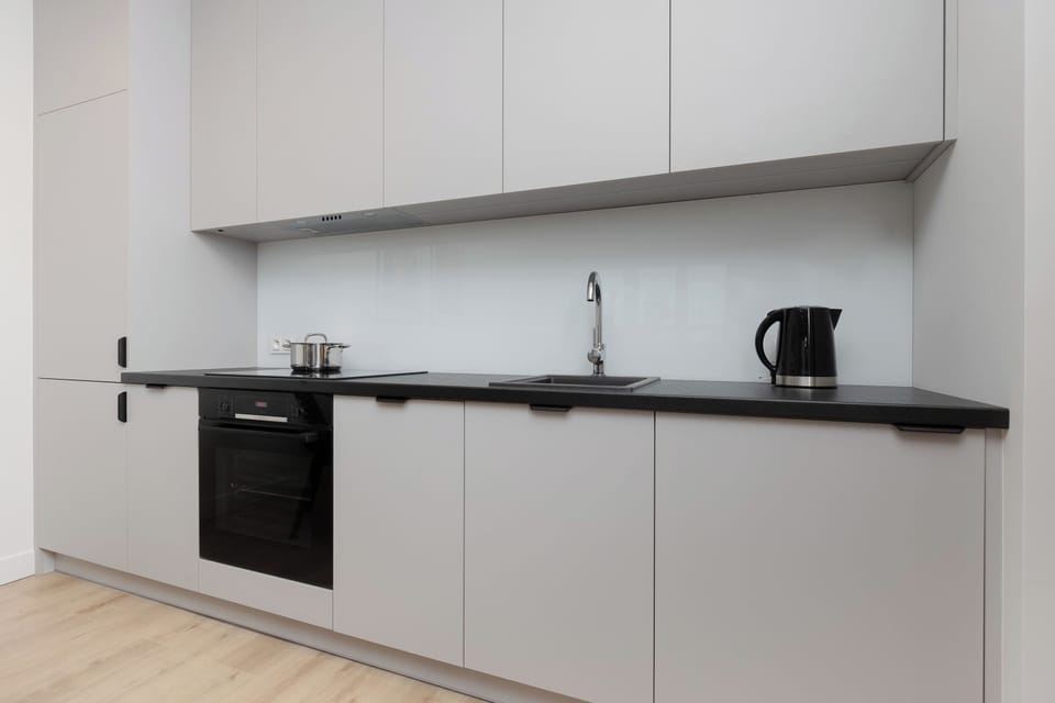 The sleek design of the kitchenette blending seamlessly with the living area.