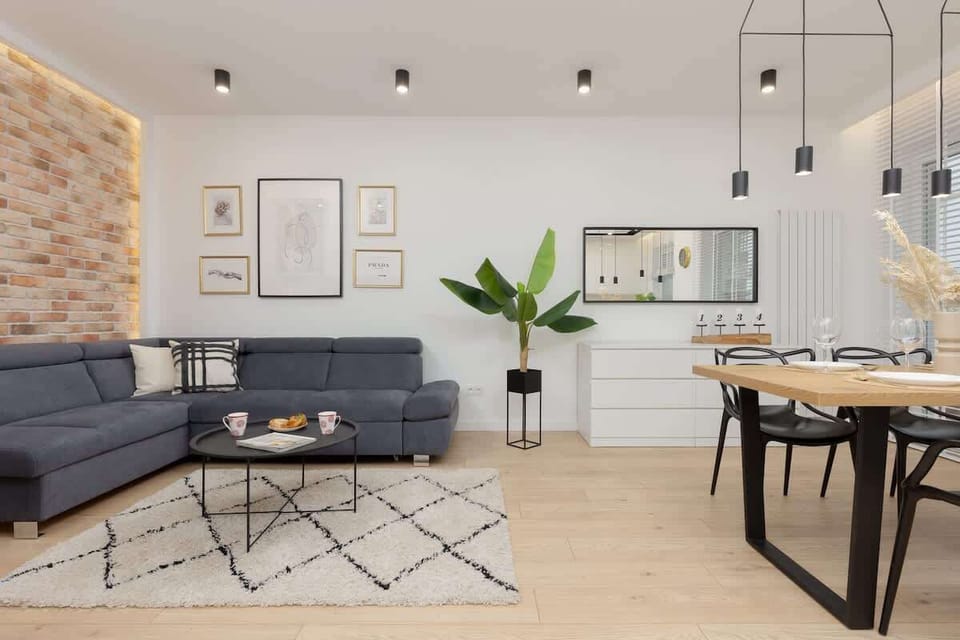 The living area features a sleek coffee table and a flat-screen television.