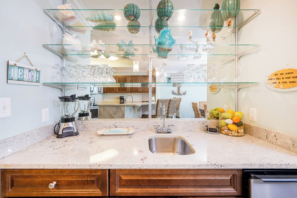 Enjoy refreshing drinks at the wet bar, surrounded by charming decor and coastal vibes perfect for relaxation