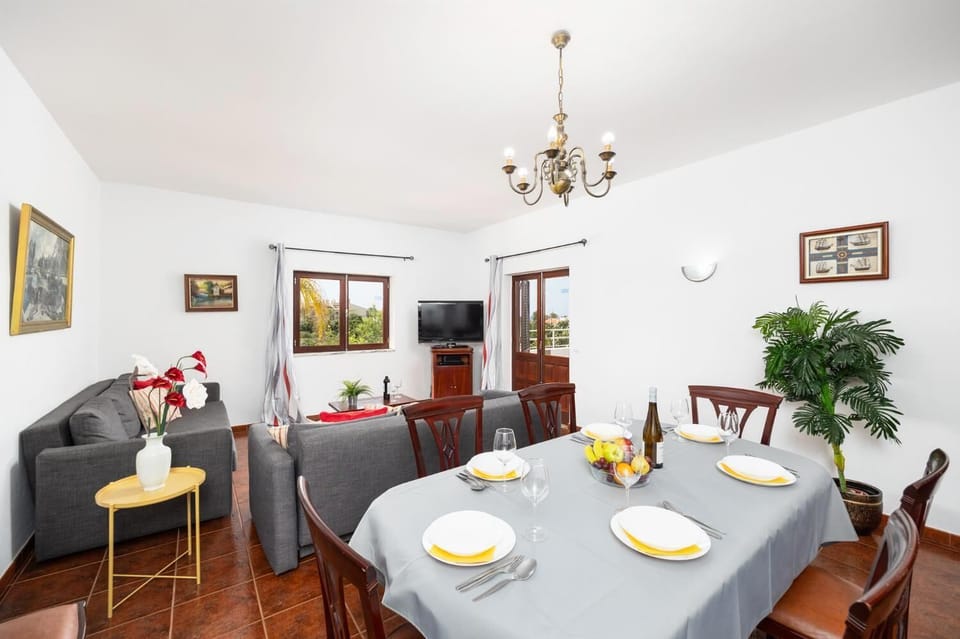 Open-plan living room with sofa, dining area, kitchen, WiFi internet, and satellite TV