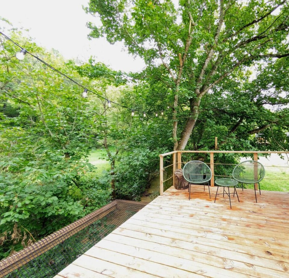 Up a few steps is your large deck with lounge seating and the favorite- the ultimate relaxation- a hammock over the creek