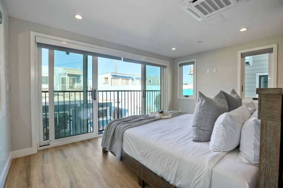 BEDROOM #3 Comfortable bedroom with a private ensuite bathroom, built-in armoire, and dresser storage, creating a relaxing and convenient retreat during your Mission Beach San Diego beach vacation just steps from the ocean and boardwalk.