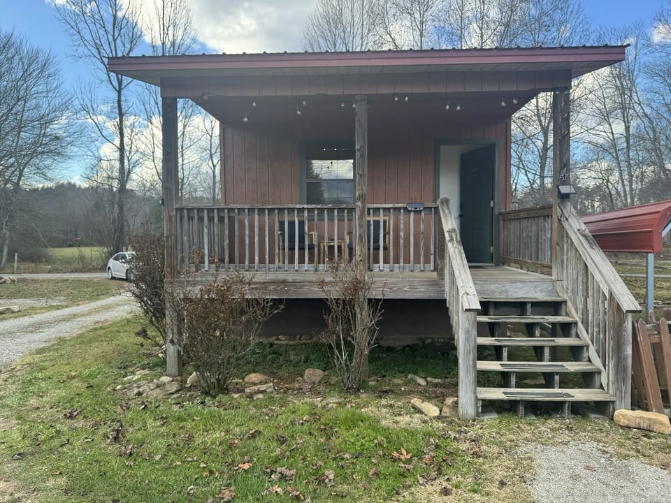 Each Cabin offers an inviting front porch with seating to enjoy the view