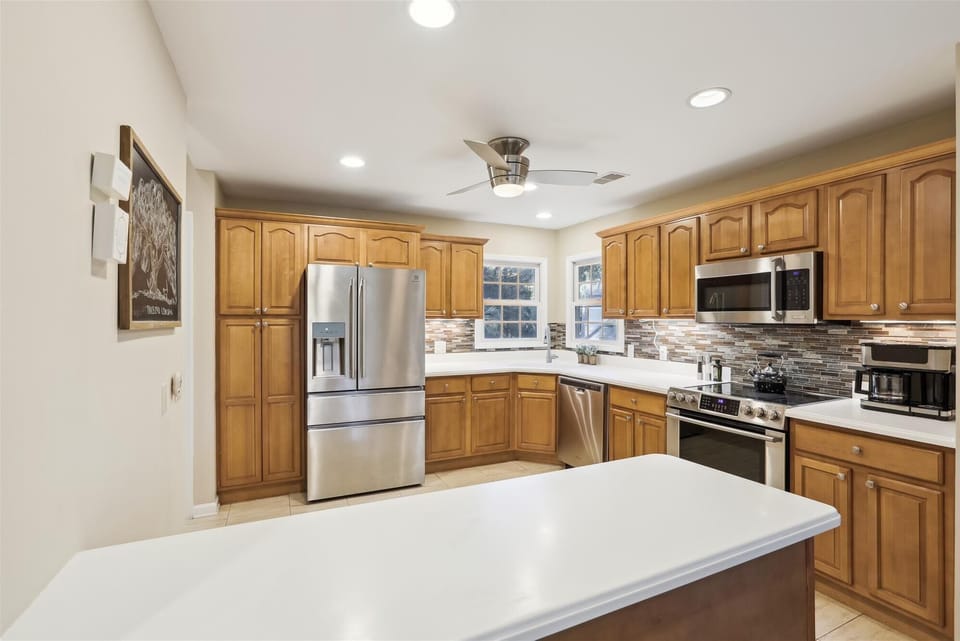 The kitchen, equipped with stainless steel appliances and a breakfast bar, is ideal for casual meals.