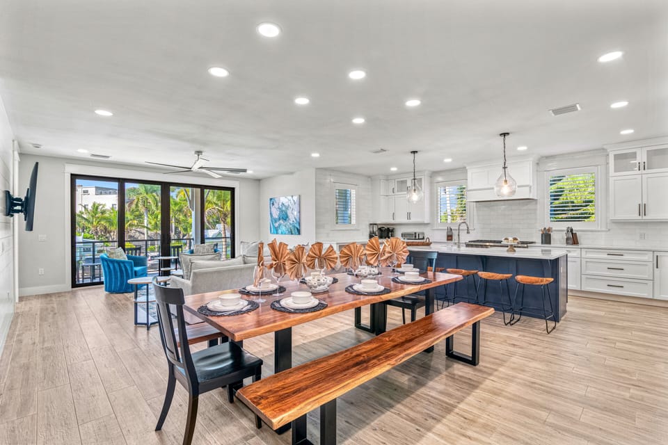 2nd Level Living, Dining with Kitchen and patio slider to the balcony in view.