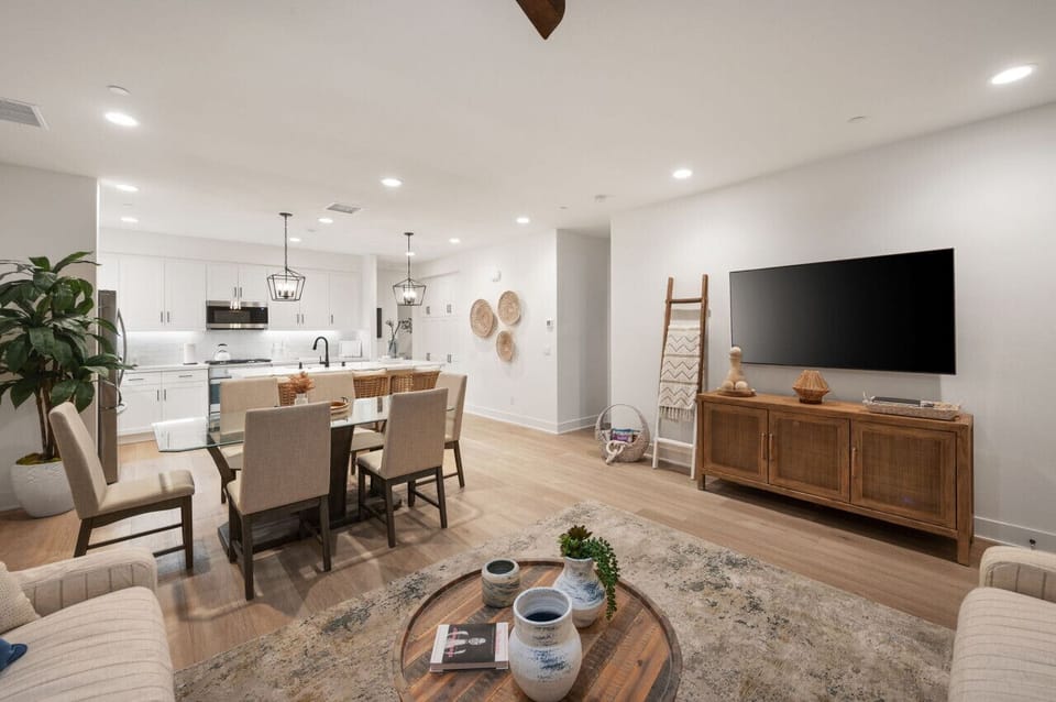 Open living & dining area w/ large TV, comfy seating & space to gather