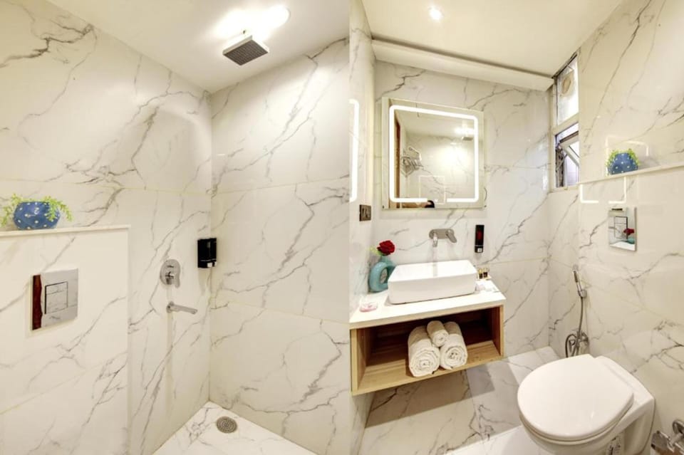 Shower, rainfall showerhead, slippers, towels