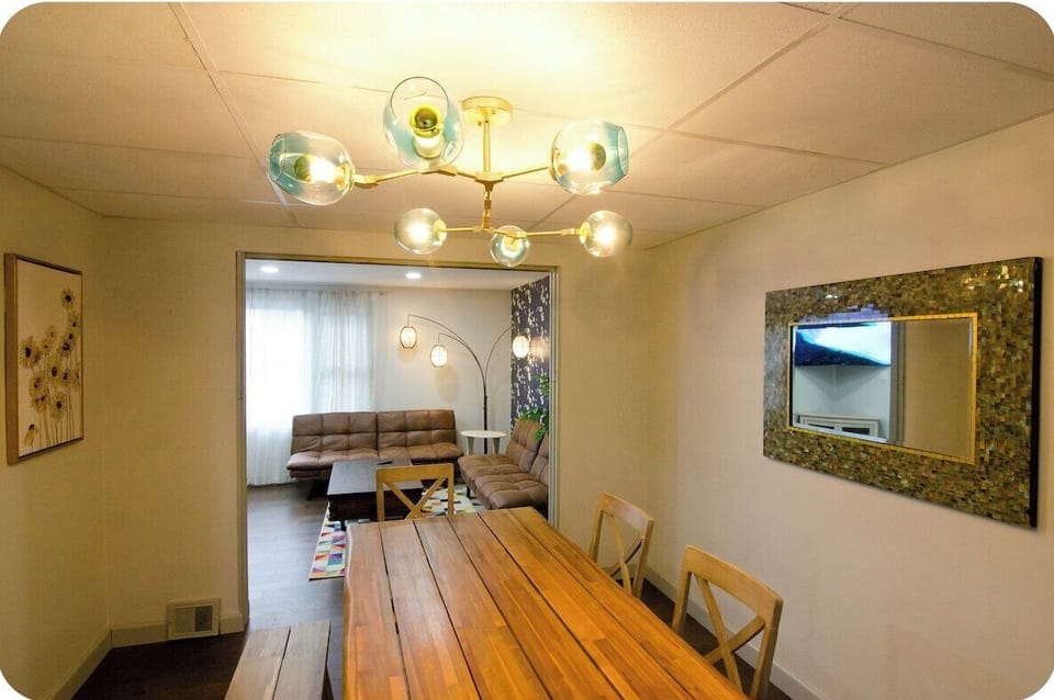 Dining area with live edge wooden table, four chairs and a bench to accommodate everyone in the group.