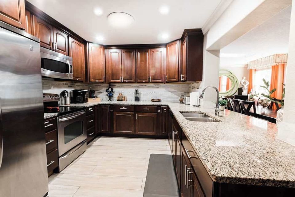 Cook and entertain in style in this stunning kitchen, featuring sleek countertops, top-of-the-line appliances, and elegant finishes that blend form and function seamlessly.