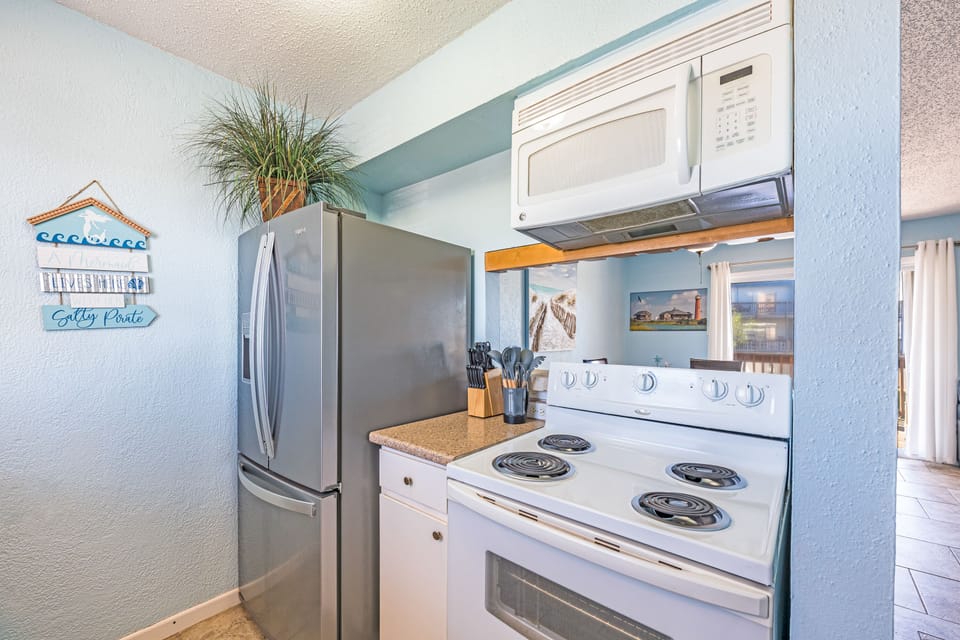 Your fully equipped kitchen features modern appliances and coastal charm, making meal prep feel like a breeze during your stay.