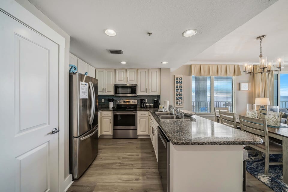 The fully equipped kitchen features granite countertops, stainless-steel appliances, and everything you need to cook meals for family and friends.