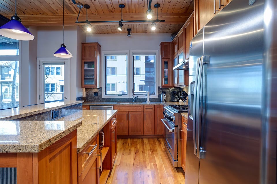 Your gourmet kitchen features granite countertops, stainless steel appliances, and warm wood finishes perfect for creating memorable meals during your stay.