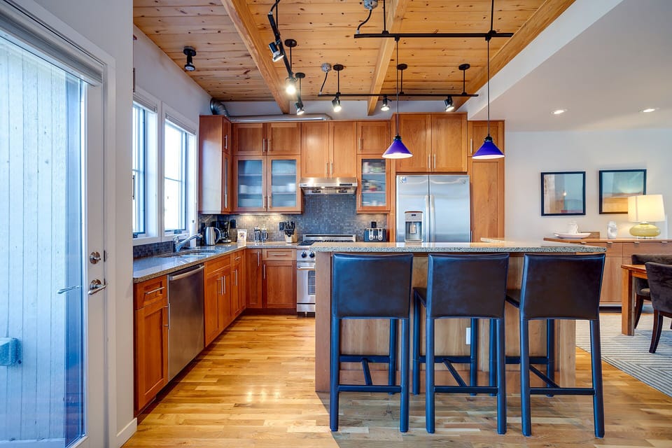 Gather around this stunning kitchen island where warm wood meets modern convenience, perfect for cooking together and sharing memorable meals.