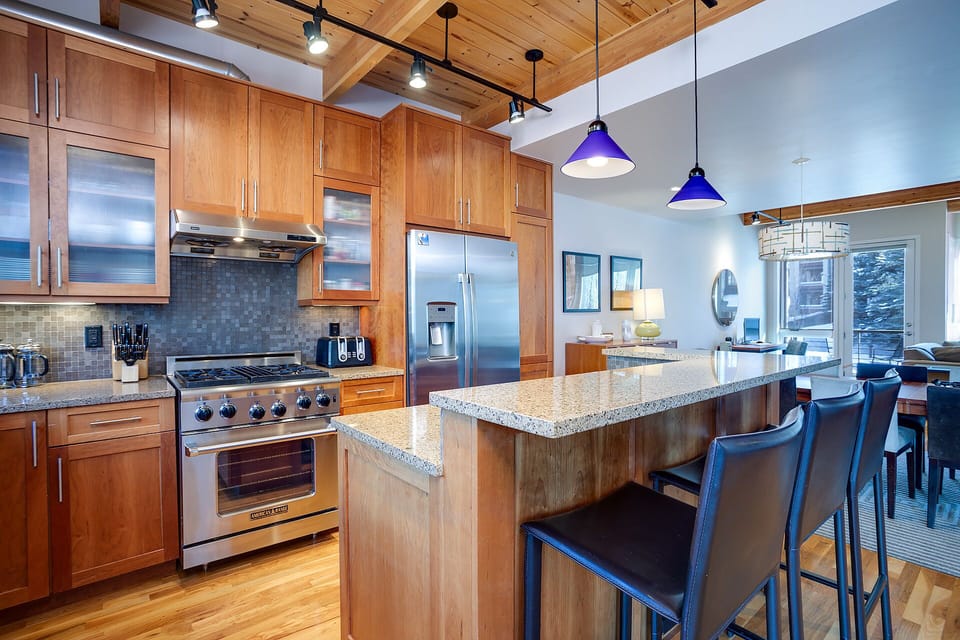 Your gourmet kitchen features granite countertops, stainless steel appliances, and a spacious island perfect for cooking memorable meals together.