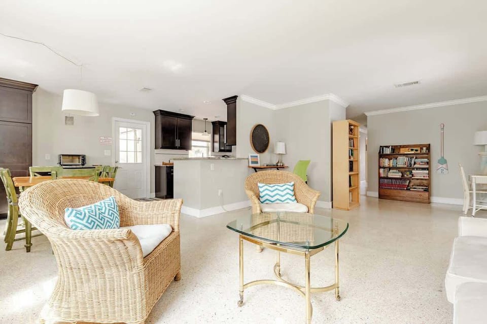 Secondary seating area with working desk next to dining and kitchen area.