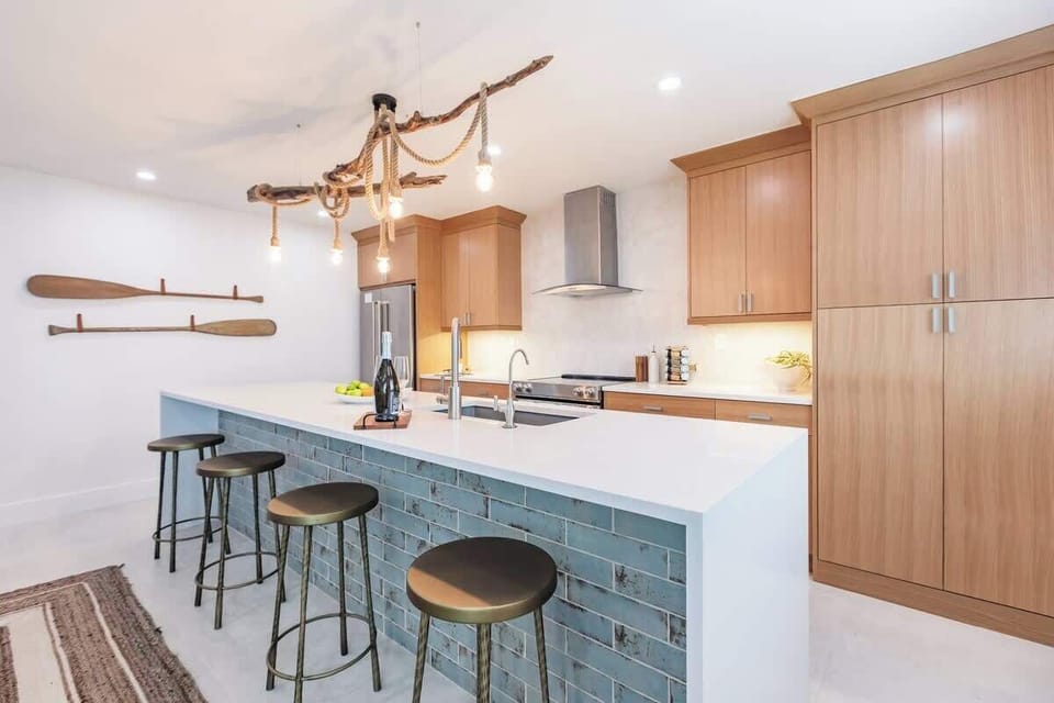 The island doubles as a prep area and a casual dining spot, allowing guests to engage with the chef of the group or simply enjoy a freshly prepared meal.