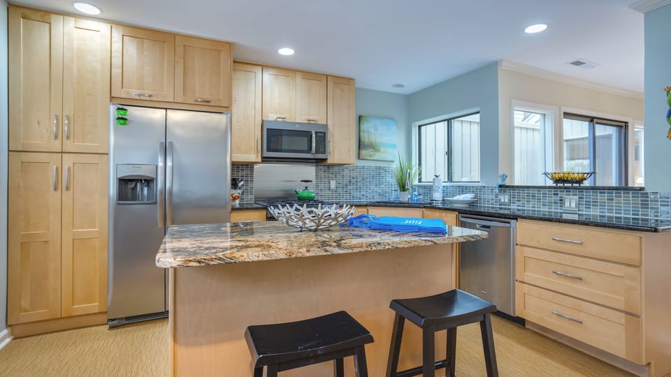 The center island with seating creates an inviting spot for casual meals or meal prep.