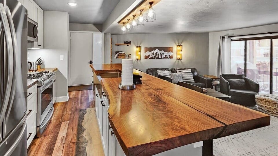 The view of the front door where the open kitchen and living room welcome you into the home.