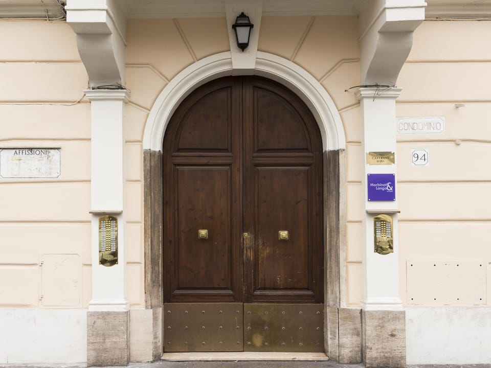 Door of the "Domus 1886" building in via Pompeo Magno 94