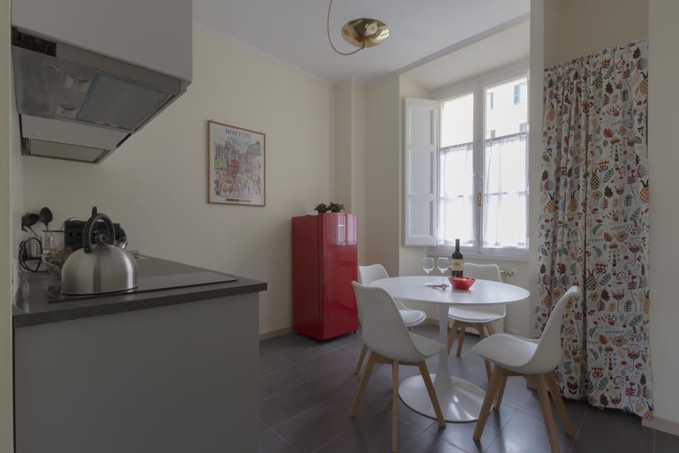 Kitchen with table and red fridge