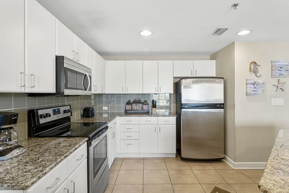modern kitchen with stainless steel appliances and granite countertops