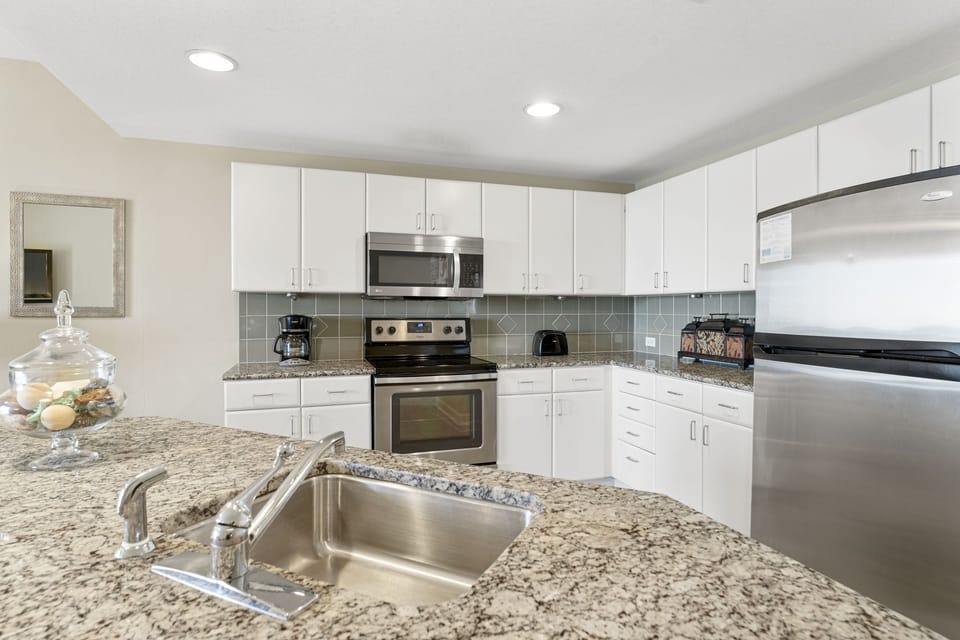 Modern kitchen with stainless steel appliances and granite countertops