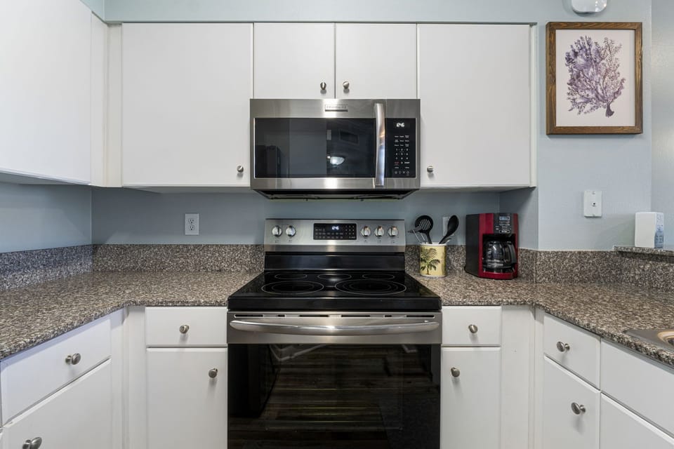 Modern kitchen with stainless steel appliances and granite countertops