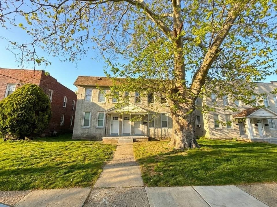 Exterior view of the building with front walkway and lawn.