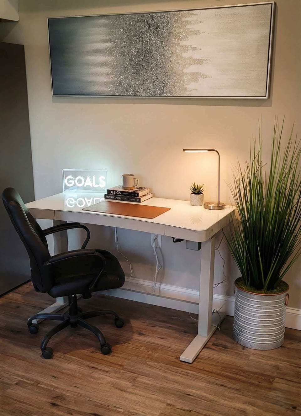 Dedicated workspace with desk, office chair, task lamp, and plant.