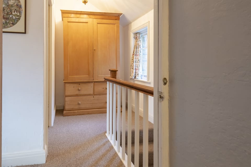 Ground floor: Comfortable seating flanks the wood burning stove at Acorn Cottage