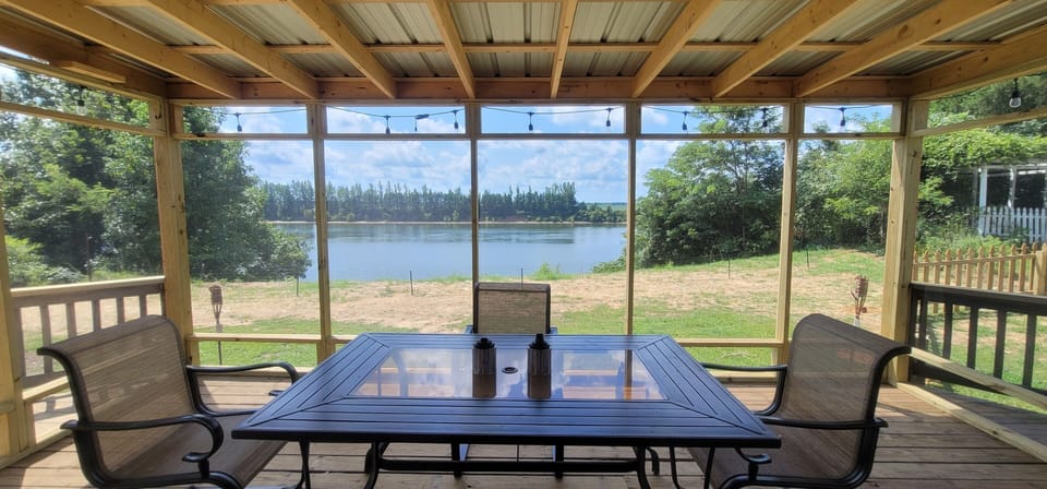 Looking out over the Tennessee River from inside the tin roof screened patio