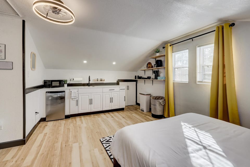 This cute kitchenette boasts a microwave, air fryer, coffee pot, mini fridge and sink.