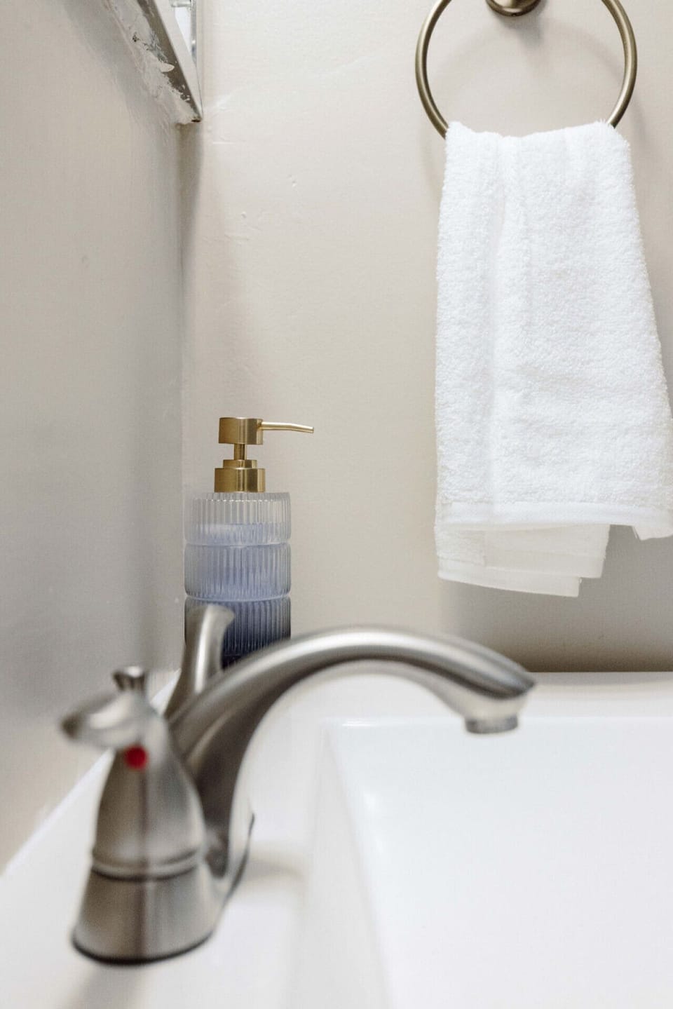 This bathroom is furnished with a toilet, sink, bathtub, and an overhead shower for your convenience