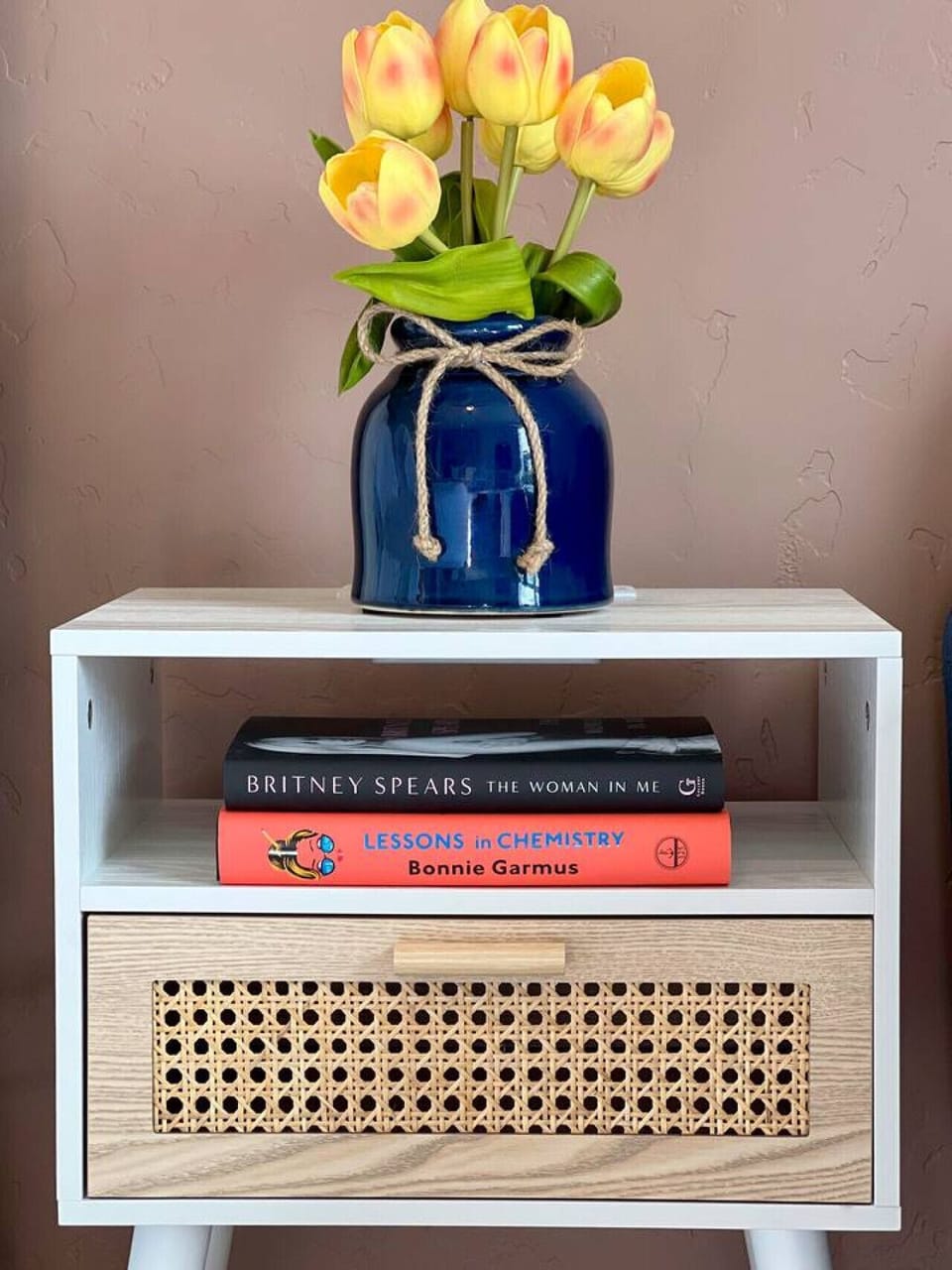 #CloudStays Cozy Corner: Charming Nightstand with Flowers, USB Plugs, and Bestselling Books for Your Reading Delight!