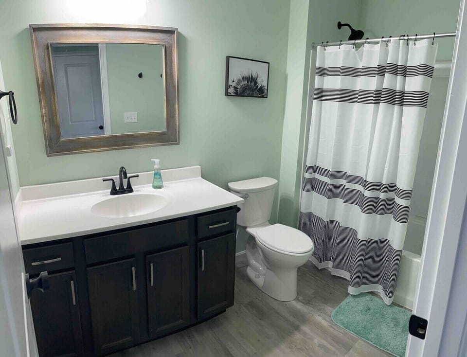 Upstairs bathroom; all natural soap, shampoo and conditioner provided along with towels, washcloths, a first aid kit, and hair dryer.